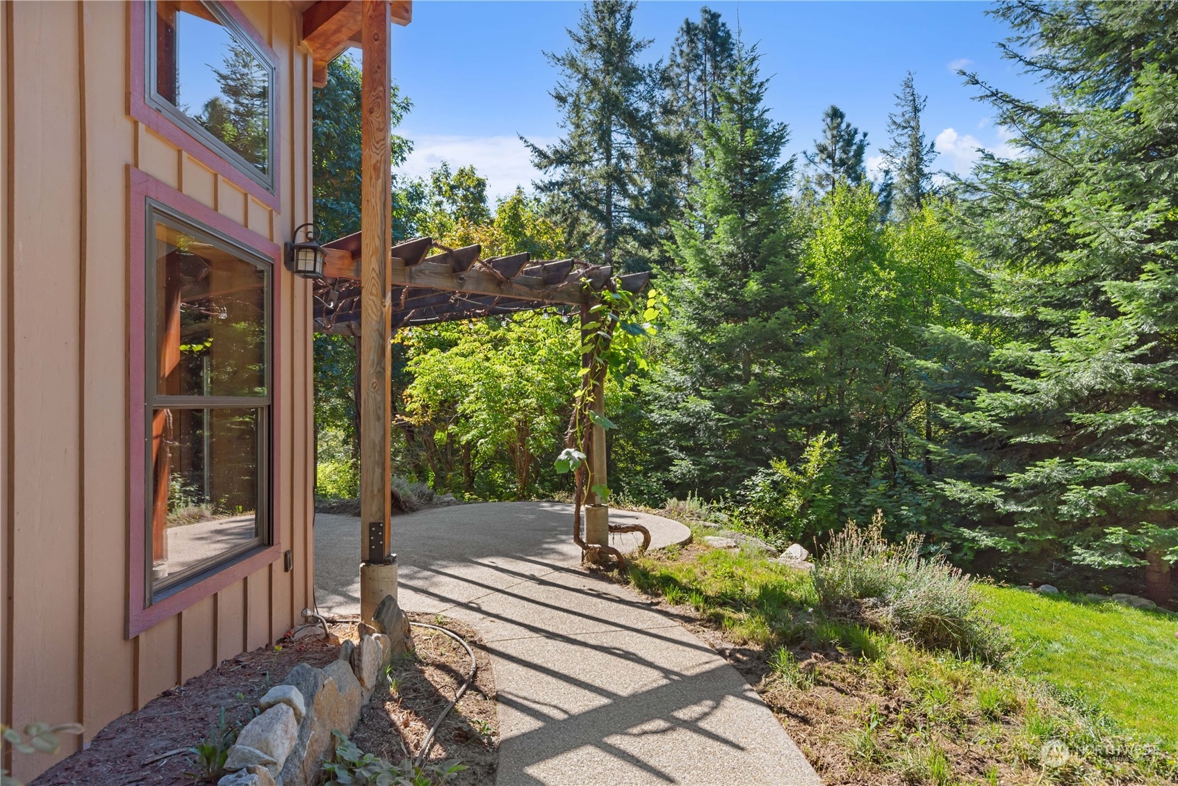 23510 White River Road Leavenworth, WA 98826 - Photo 8 of 39 a view of a patio with table and chairs and floor to ceiling window