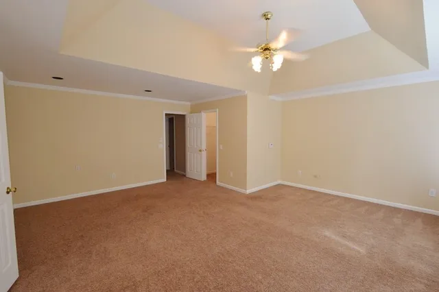 a spacious bathroom with a tub sink and mirror