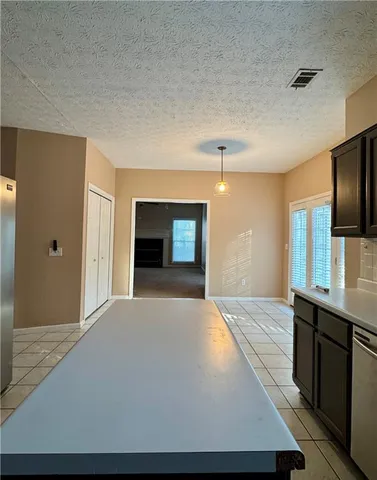 a large bedroom with a bed and a flat screen tv