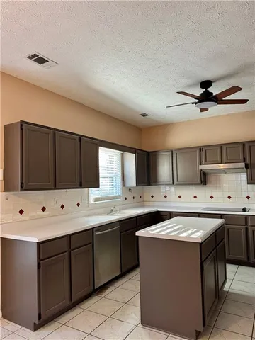 a view of empty room with a fireplace