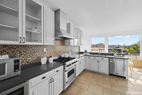 a bedroom with a bed mirror and window