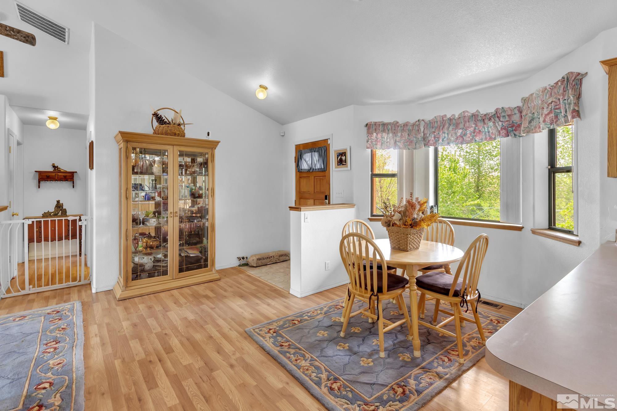 1340 Antelope Valley Road Reno, NV 89506 - Photo 5 of 40 a dining room with wooden floor and large window