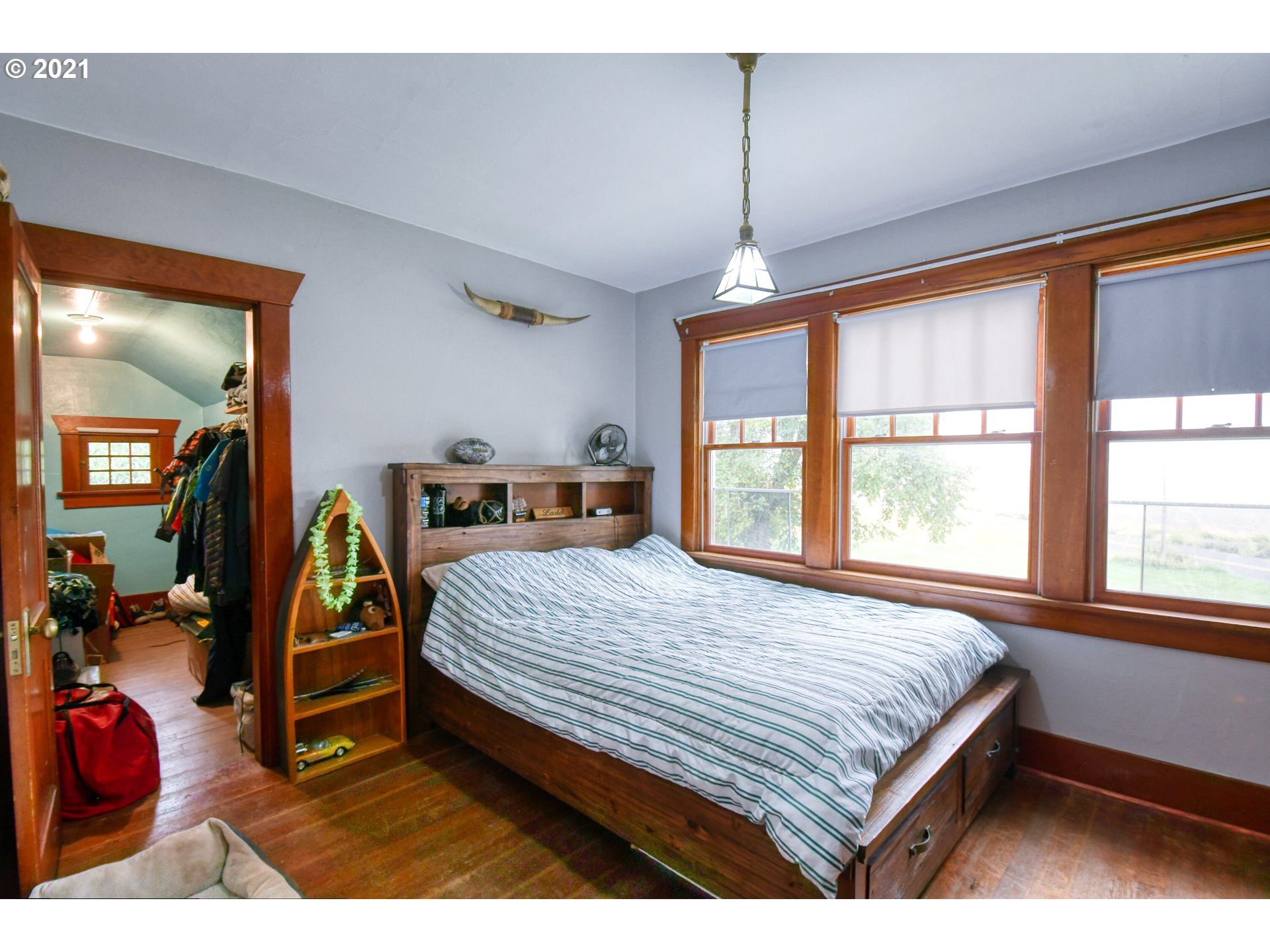 76223 Spring Hollow Road Adams, OR 97810 - Photo 23 of 30 a bedroom with a bed a mirror and window