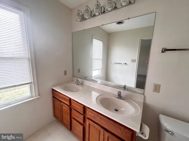a bathroom with a sink double vanity and a window