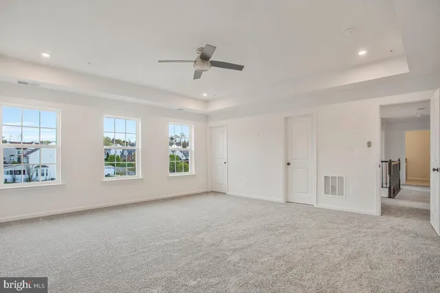 an empty room with windows and closet