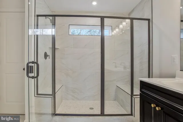 a bathroom with a glass shower door