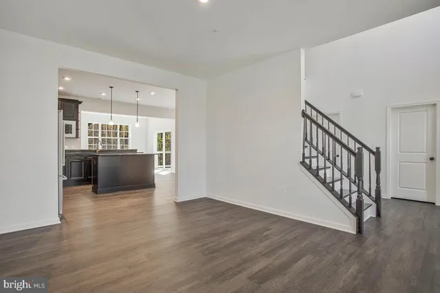 a view of a kitchen with wooden floor and electronic appliances
