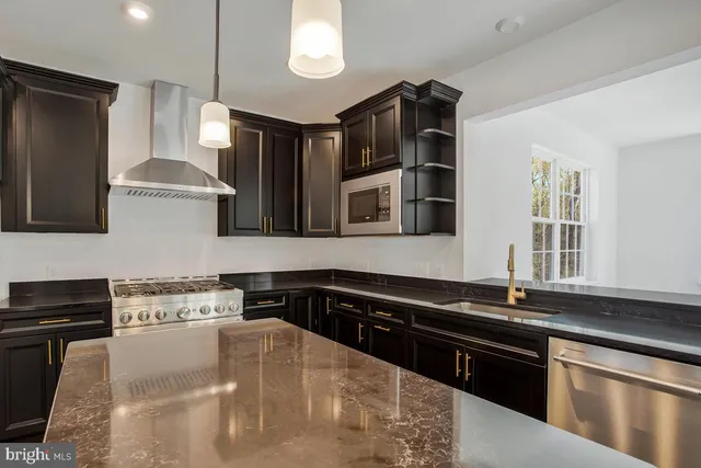 a kitchen with granite countertop a stove and a sink