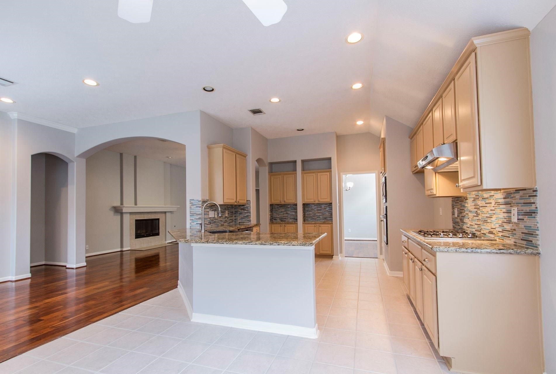 1230 Sienna Hill Drive Houston, TX 77077 - Photo 14 of 42 a large kitchen with stainless steel appliances kitchen island granite countertop a large counter top and a stove