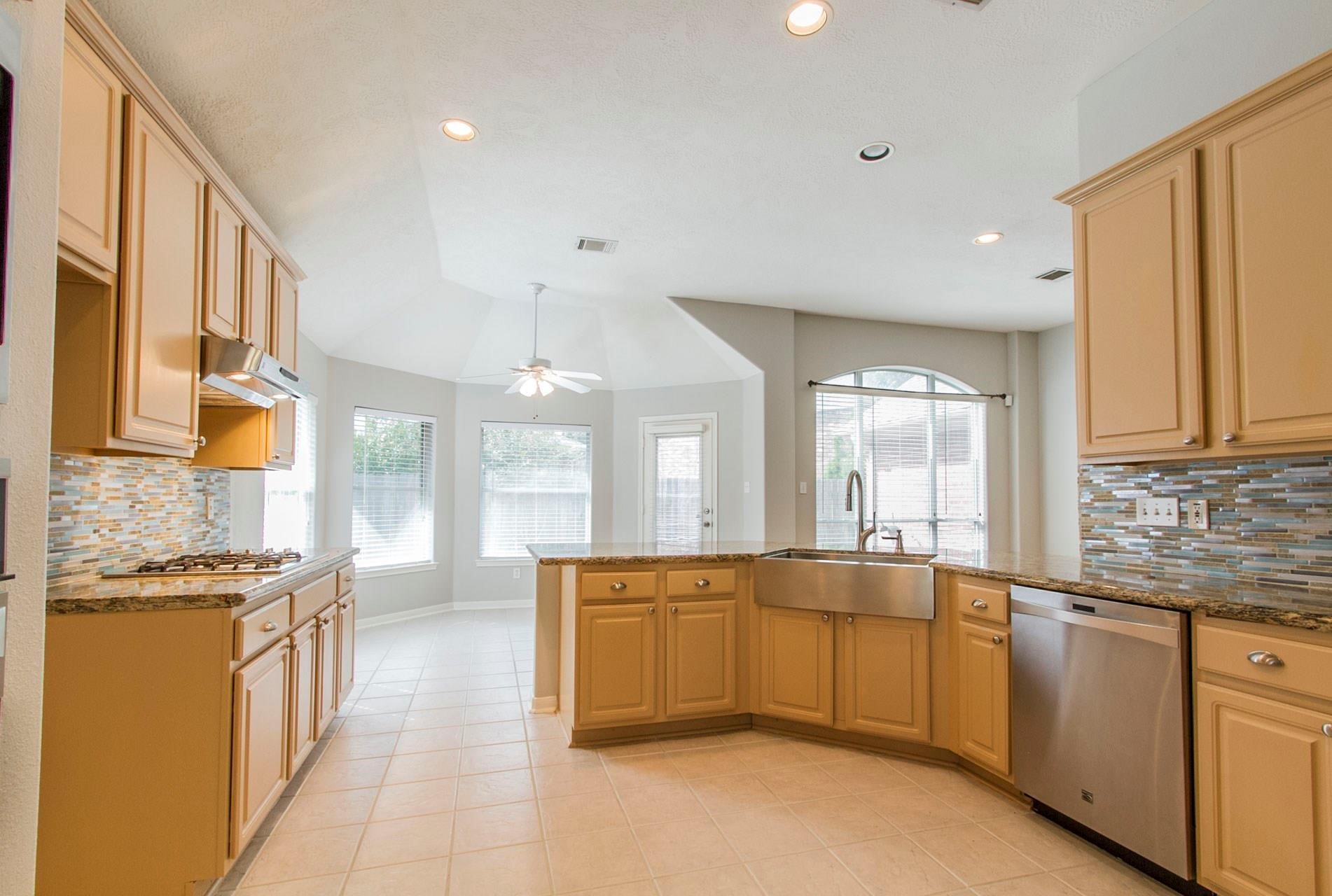 1230 Sienna Hill Drive Houston, TX 77077 - Photo 16 of 42 a large kitchen with stainless steel appliances lots of counter space and a sink