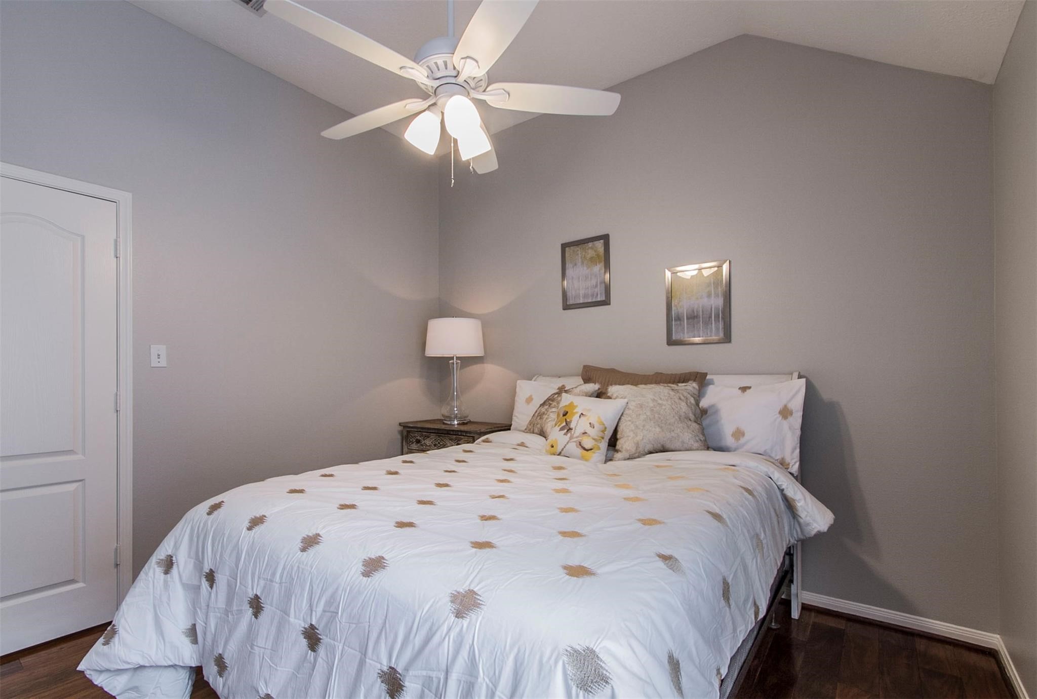 1230 Sienna Hill Drive Houston, TX 77077 - Photo 19 of 42 a bedroom with a bed and a chandelier