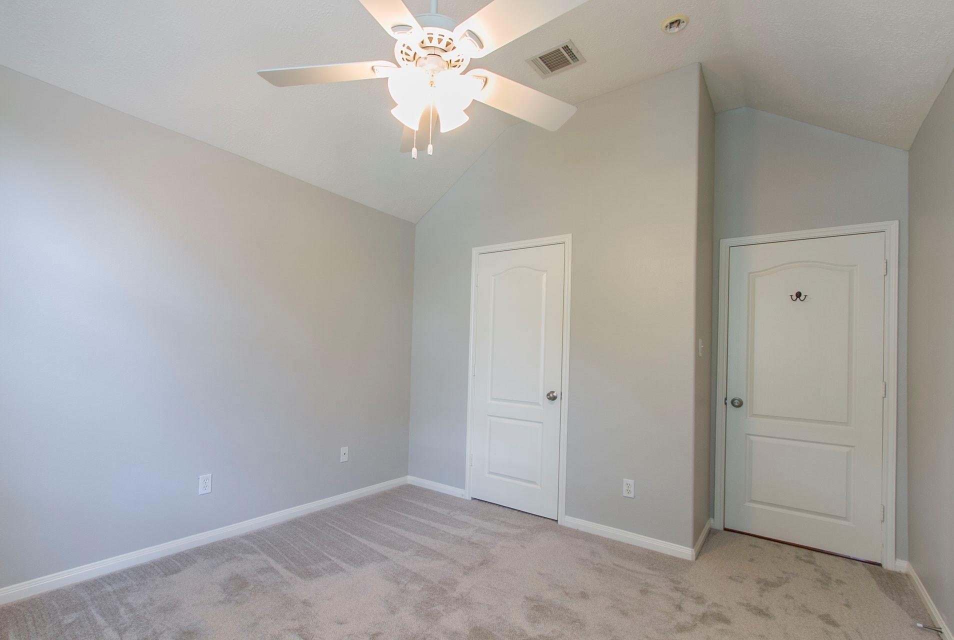 1230 Sienna Hill Drive Houston, TX 77077 - Photo 20 of 42 an empty room with a chandelier fan