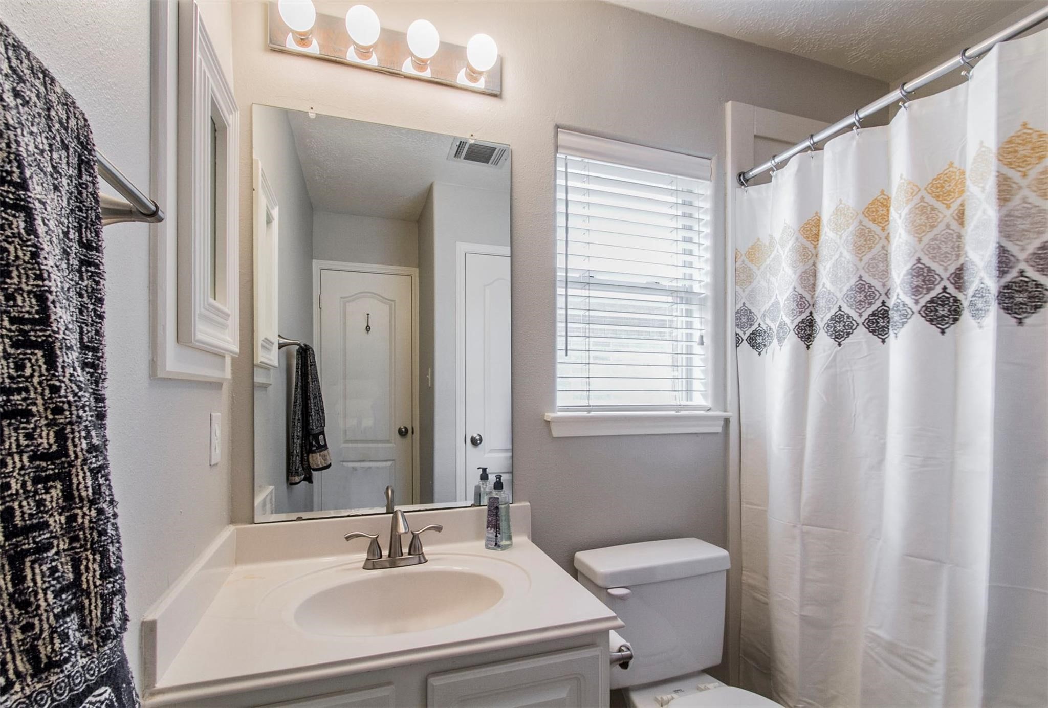1230 Sienna Hill Drive Houston, TX 77077 - Photo 22 of 42 a bathroom with a sink a toilet and shower