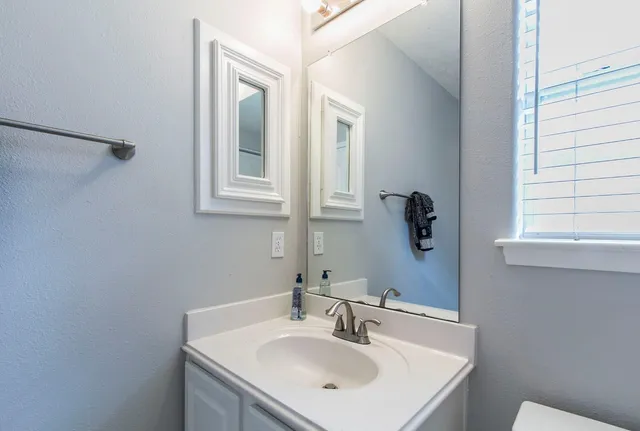 a bathroom with a sink and a mirror
