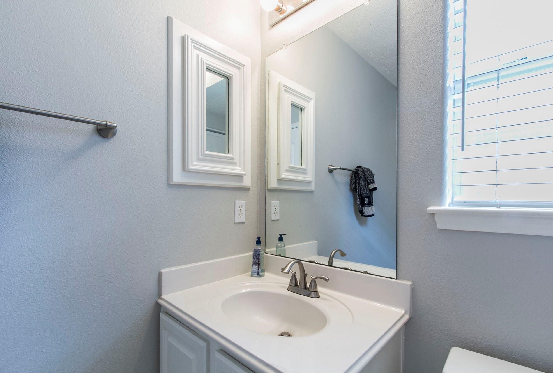 1230 Sienna Hill Drive Houston, TX 77077 - Photo 23 of 42 a bathroom with a sink and a mirror