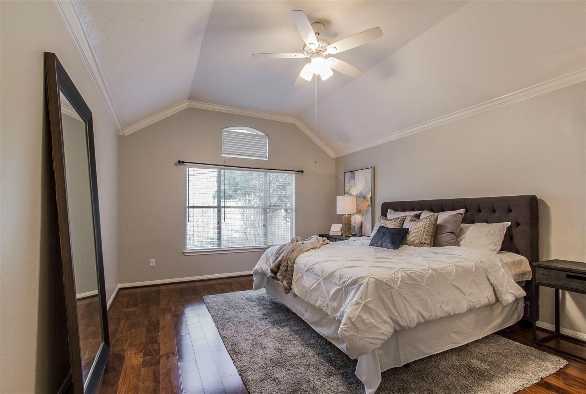 1230 Sienna Hill Drive Houston, TX 77077 - Photo 25 of 42 a bedroom with a large bed and a chandelier