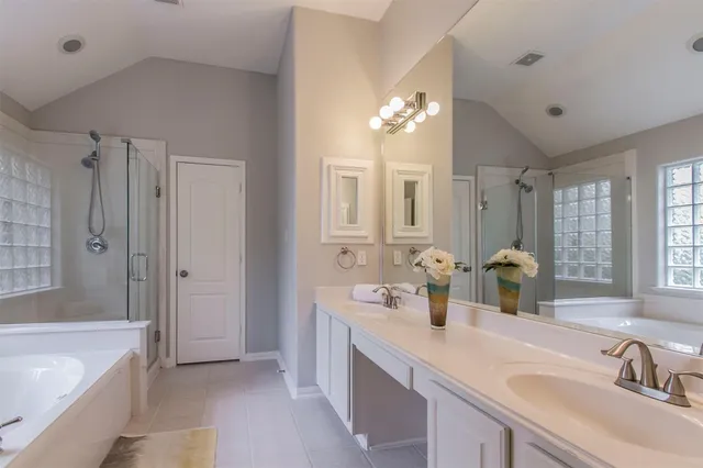 a bathroom with a double vanity sink bathtub double and shower