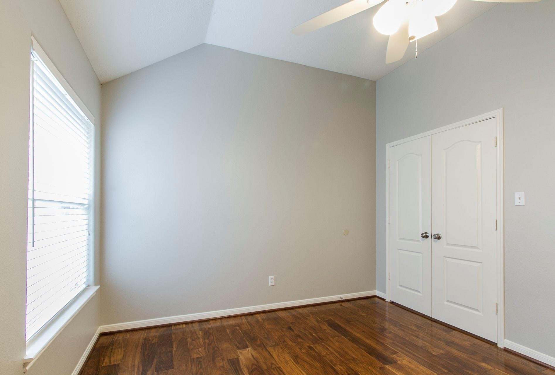 1230 Sienna Hill Drive Houston, TX 77077 - Photo 34 of 42 an empty room with wooden floor and window