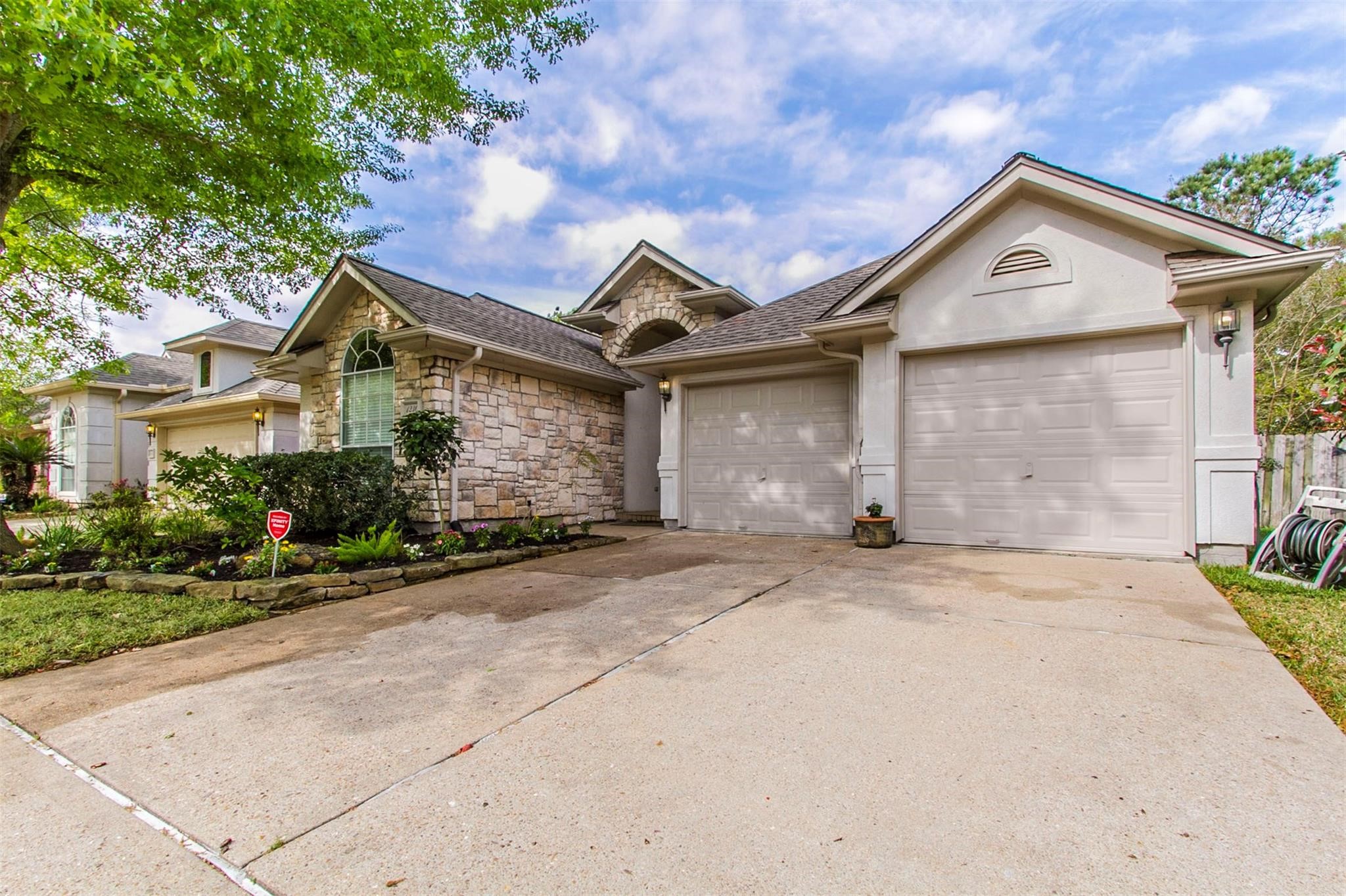 1230 Sienna Hill Drive Houston, TX 77077 - Photo 40 of 42 a front view of a house with a yard and garage