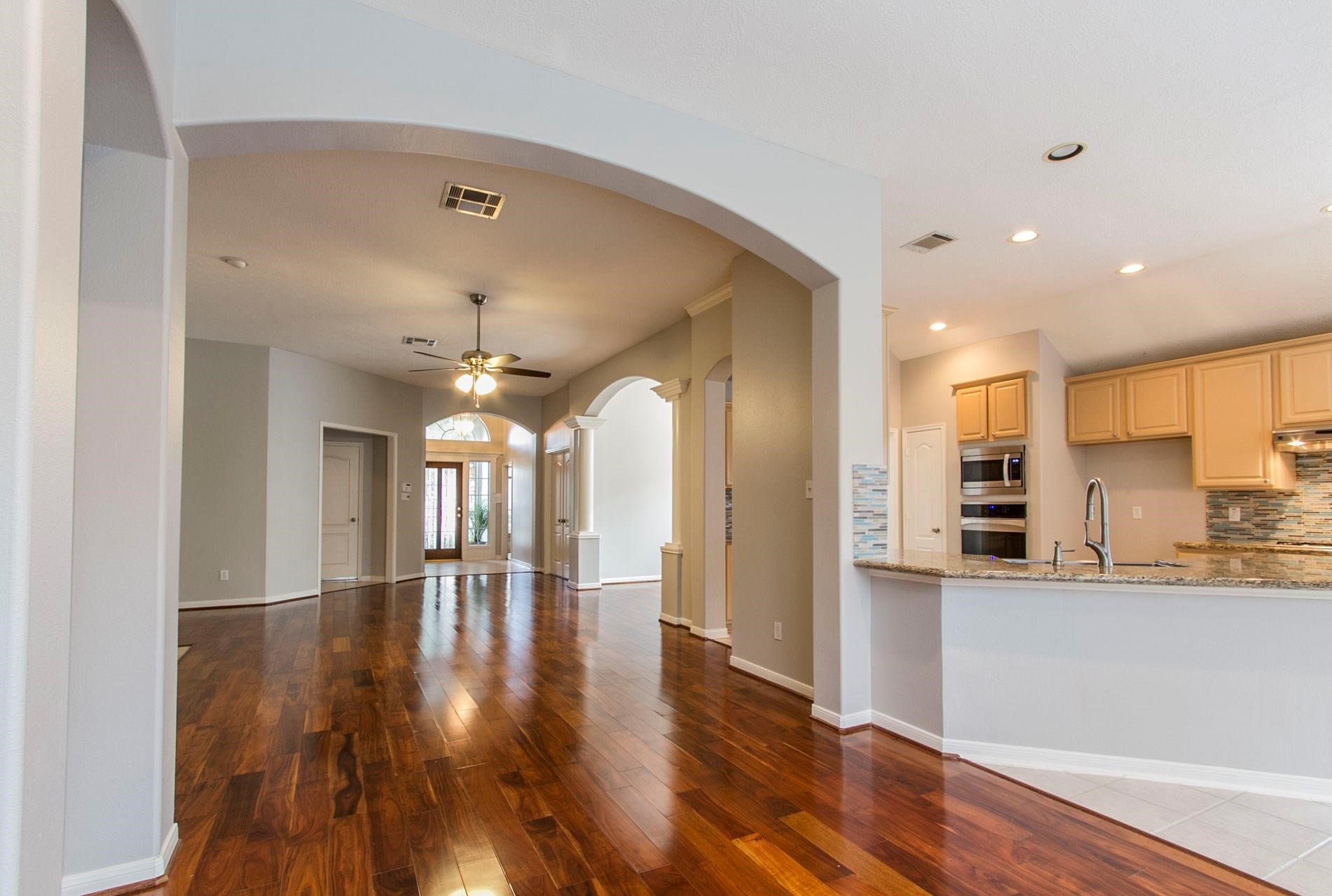 1230 Sienna Hill Drive Houston, TX 77077 - Photo 4 of 42 a view of a large kitchen with a large window and wooden floor