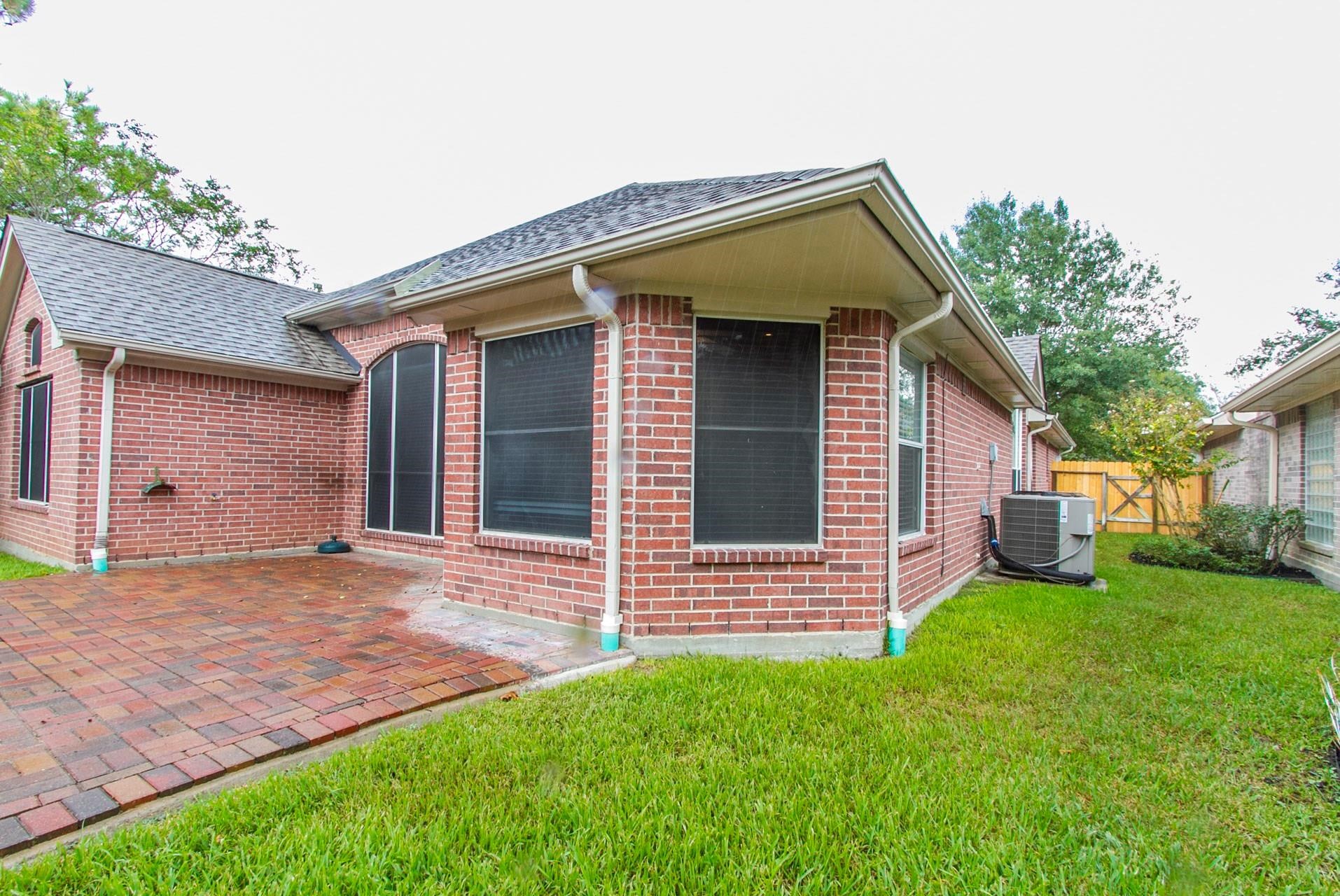 1230 Sienna Hill Drive Houston, TX 77077 - Photo 42 of 42 a front view of a house with a garden and yard