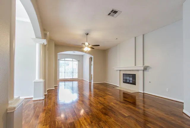 wooden floor in an empty room with a window