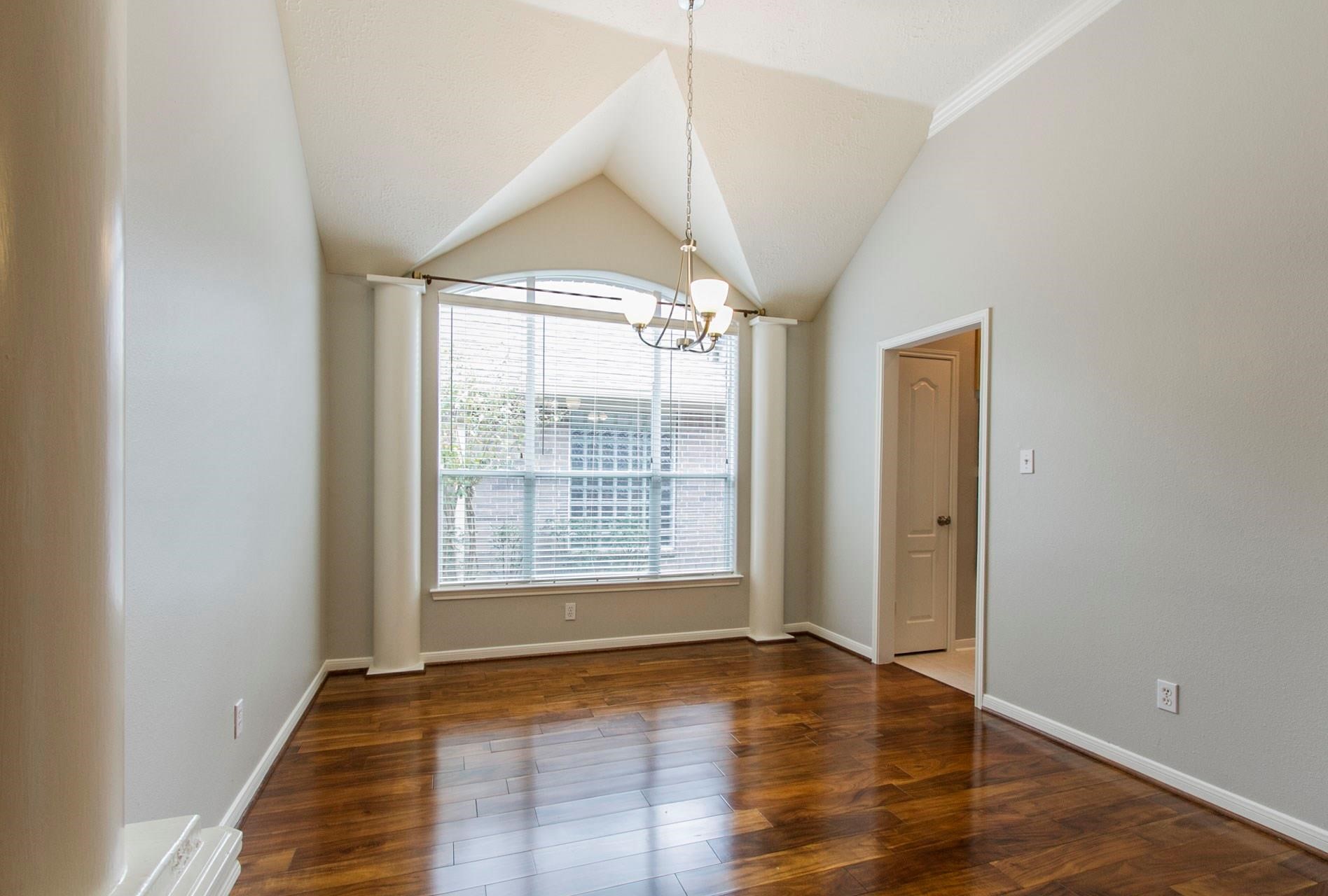 1230 Sienna Hill Drive Houston, TX 77077 - Photo 10 of 42 a view of an empty room with wooden floor and a window