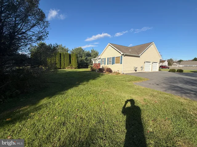 a view of a house with a backyard