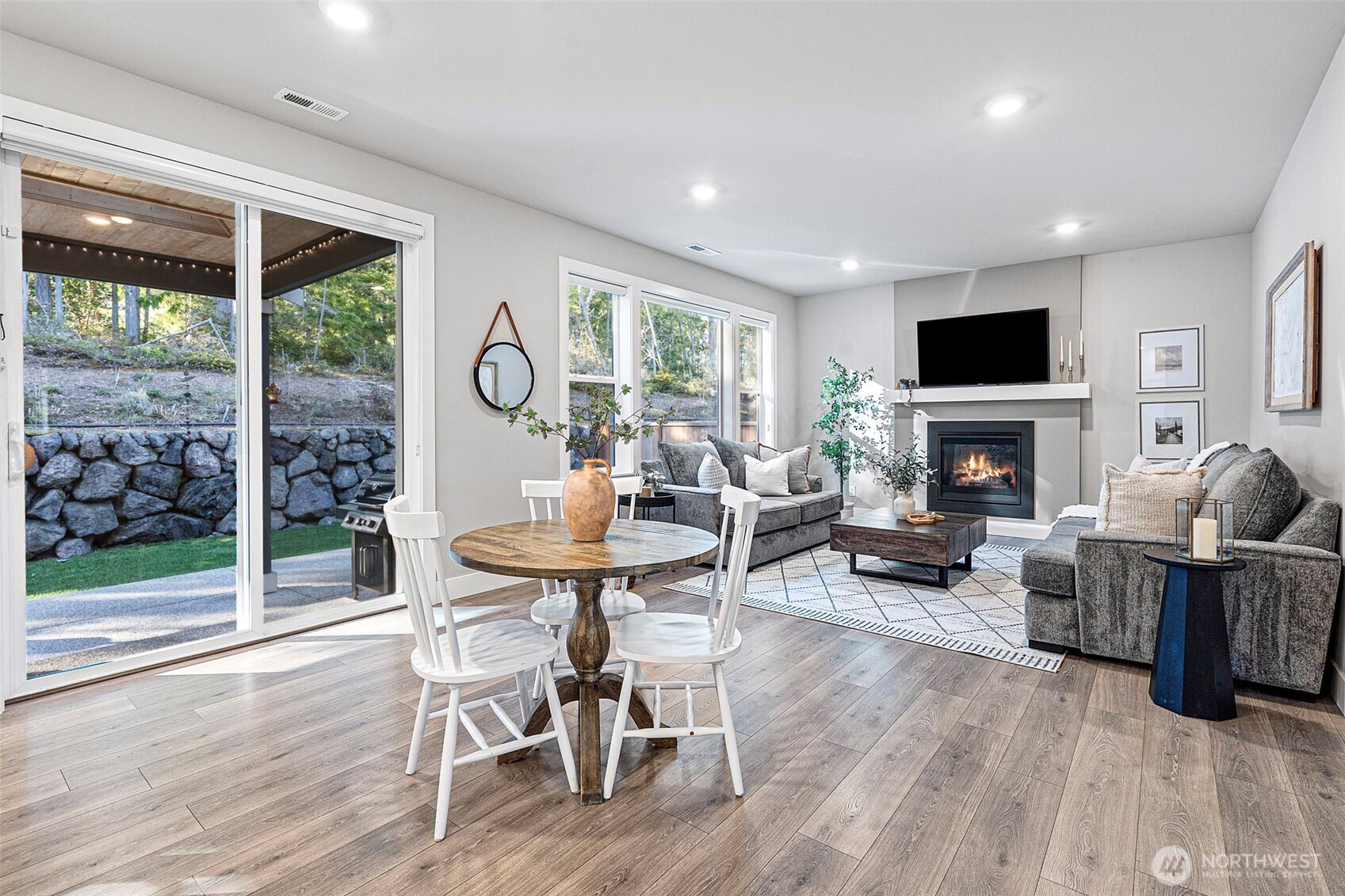 4526 Olympus Loop Gig Harbor, WA 98332 - Photo 12 of 38 a living room with furniture a flat screen tv and a fireplace