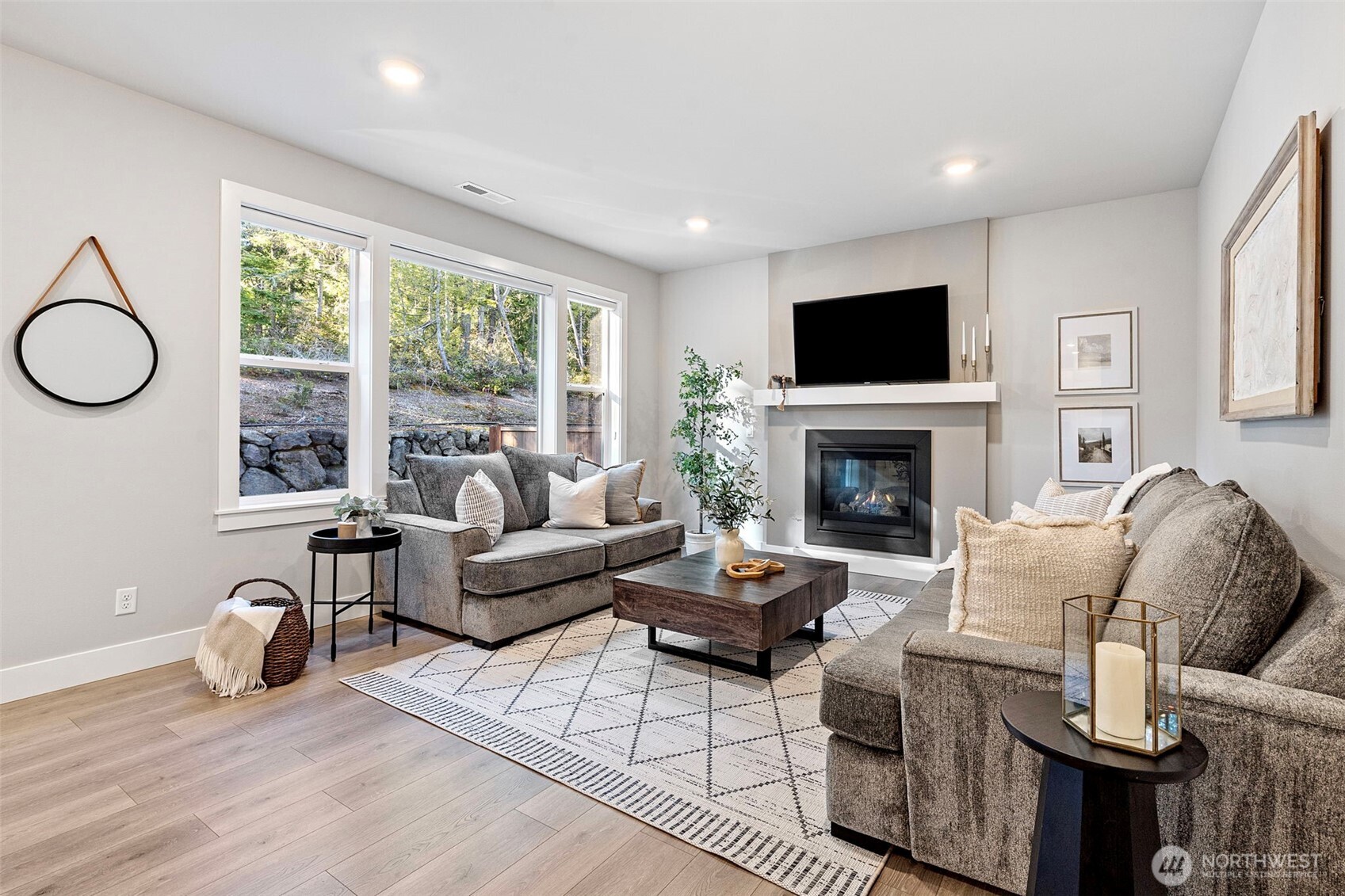 4526 Olympus Loop Gig Harbor, WA 98332 - Photo 13 of 38 a living room with furniture a flat screen tv and a fireplace