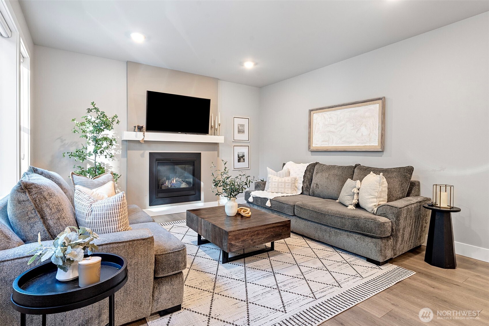 4526 Olympus Loop Gig Harbor, WA 98332 - Photo 14 of 38 a living room with furniture a flat screen tv and a fireplace