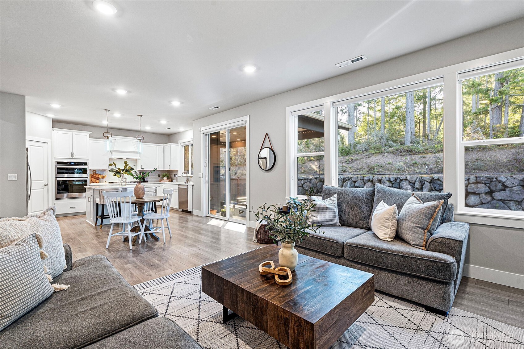4526 Olympus Loop Gig Harbor, WA 98332 - Photo 15 of 38 a living room with furniture kitchen view and a large window