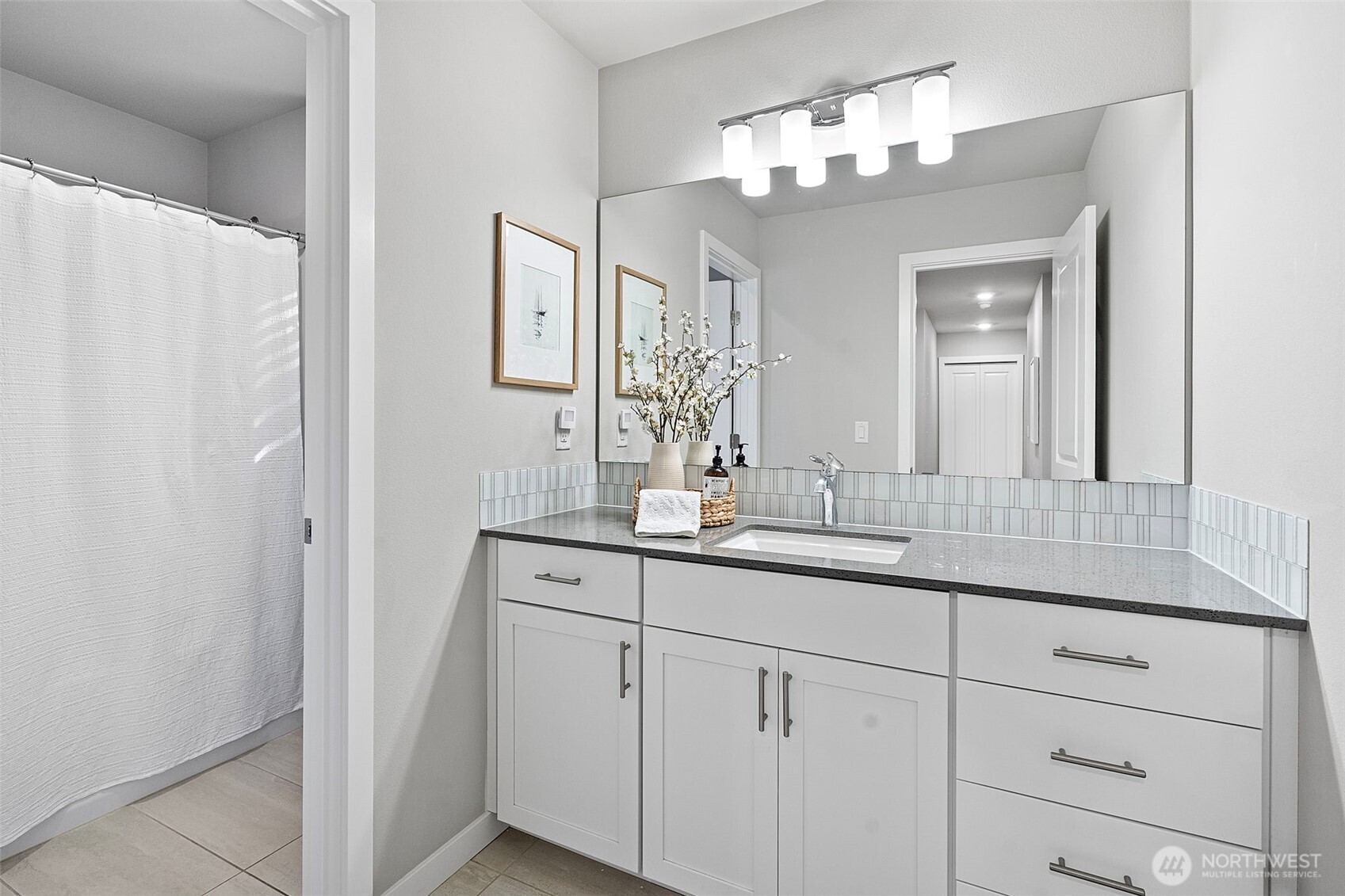 4526 Olympus Loop Gig Harbor, WA 98332 - Photo 24 of 38 a bathroom with a double vanity sink and a mirror