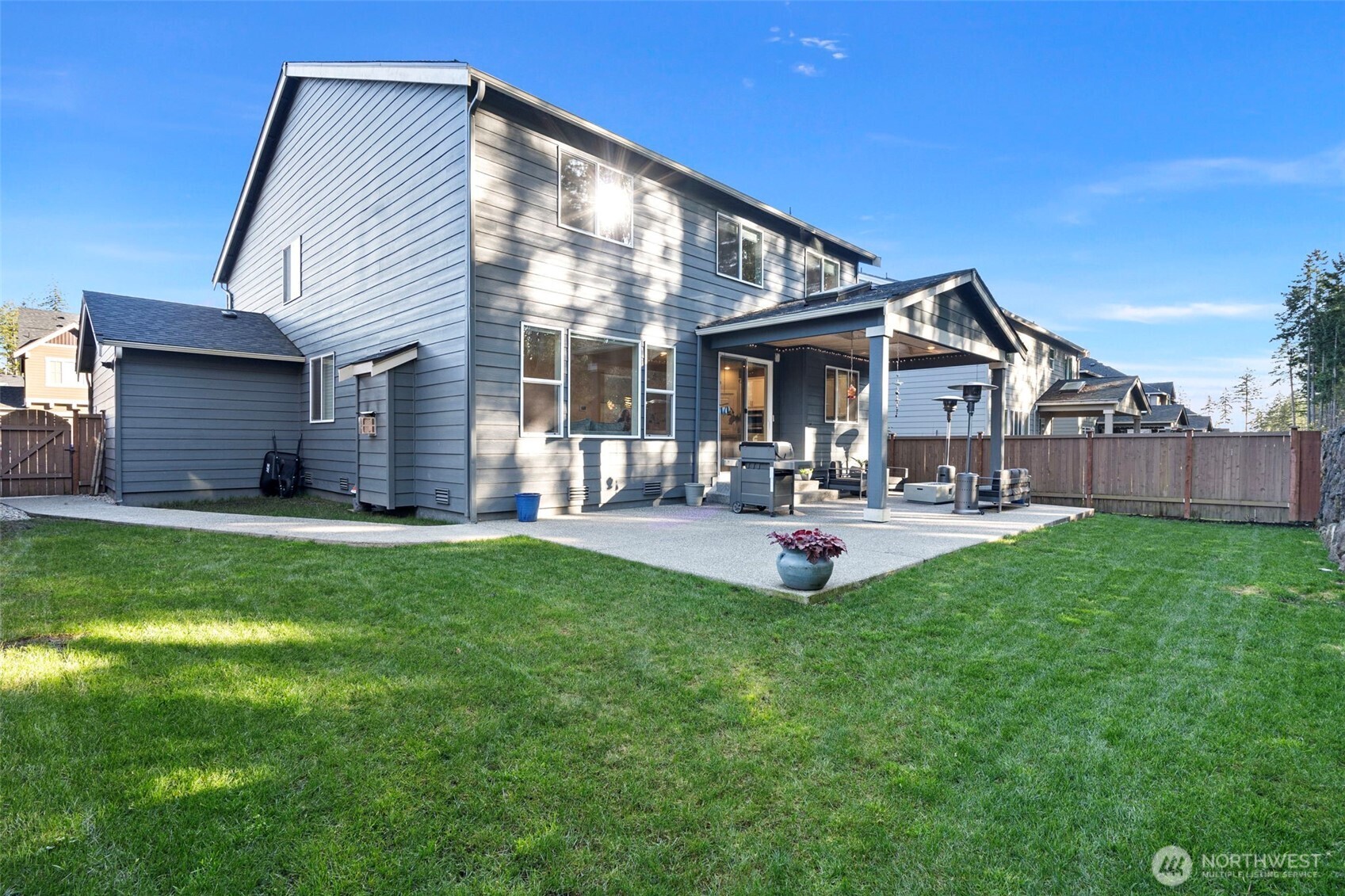 4526 Olympus Loop Gig Harbor, WA 98332 - Photo 30 of 38 a view of a house with patio and a yard