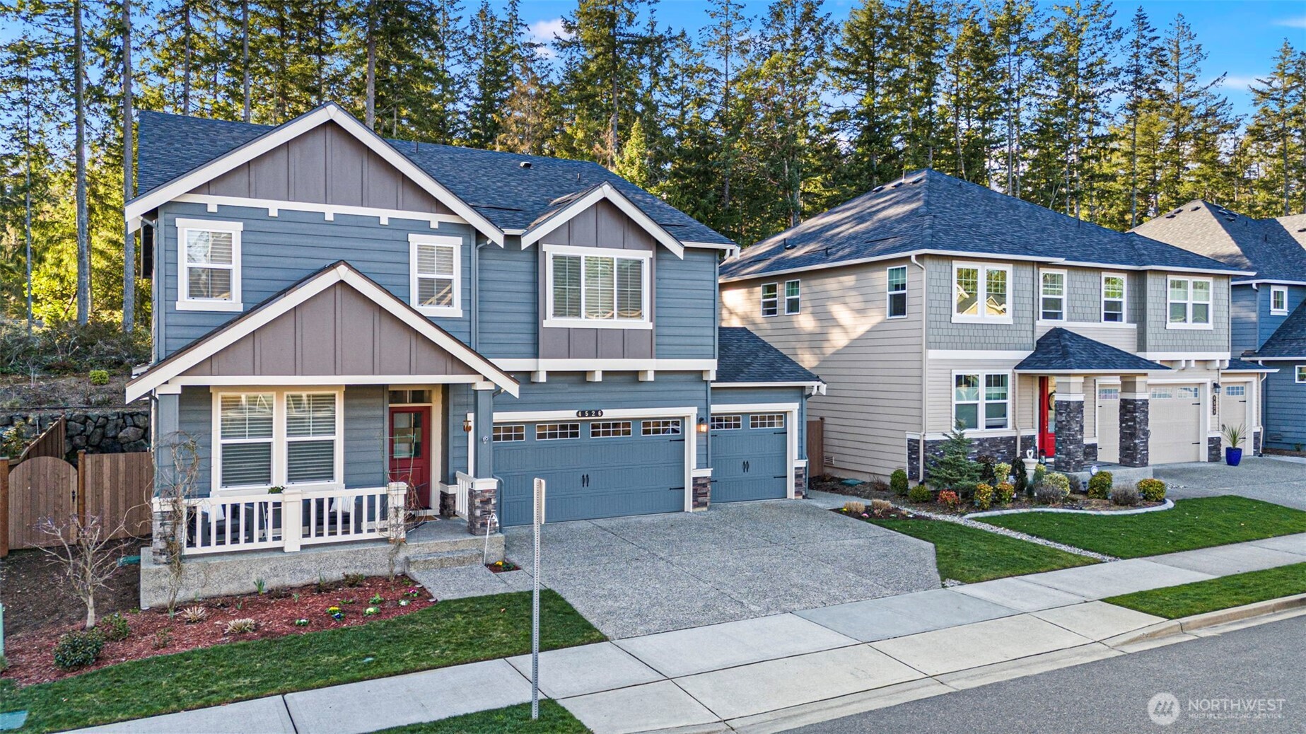 4526 Olympus Loop Gig Harbor, WA 98332 - Photo 31 of 38 a front view of a house with a yard and potted plants