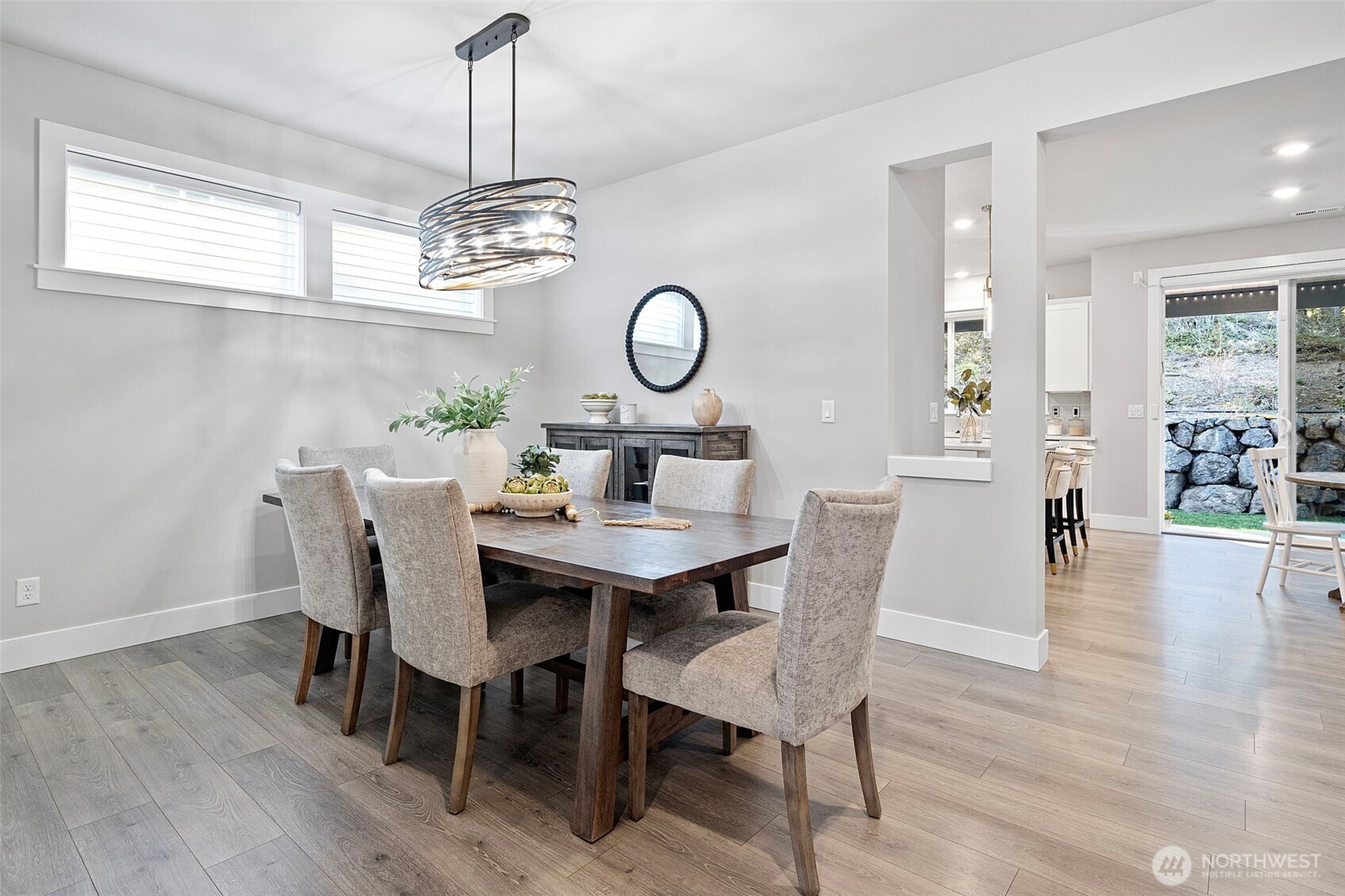 4526 Olympus Loop Gig Harbor, WA 98332 - Photo 5 of 38 a view of a dining room with furniture wooden floor and a chandelier