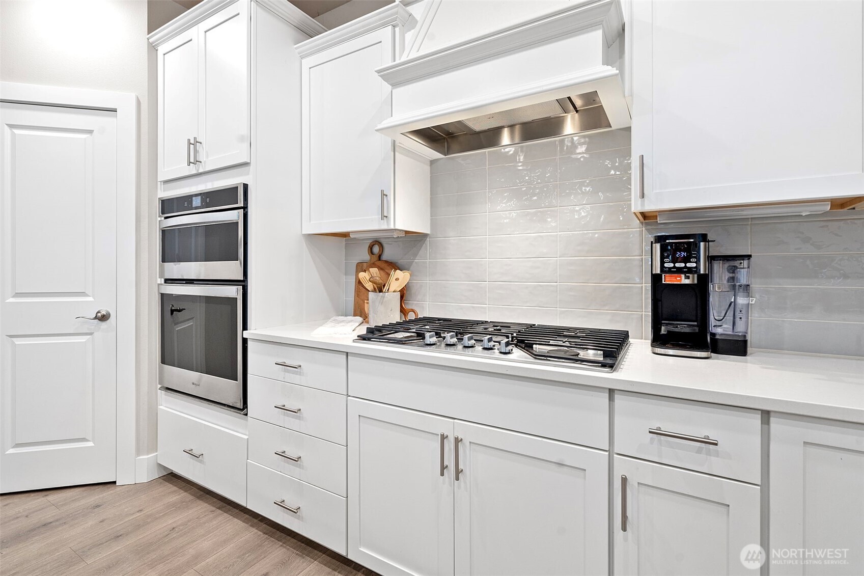 4526 Olympus Loop Gig Harbor, WA 98332 - Photo 9 of 38 a kitchen with white cabinets and appliances