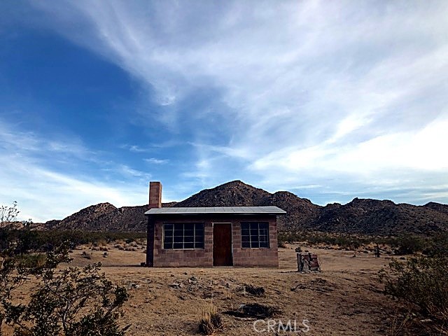51050 Cholla Road Johnson Valley, CA 92285 - Photo 3 of 11 a front view of a house with a yard