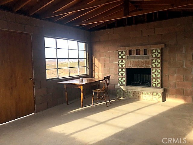 51050 Cholla Road Johnson Valley, CA 92285 - Photo 5 of 11 a workspace with furniture and a fireplace