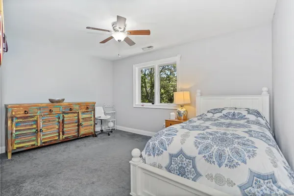 a bedroom with a bed and a dresser