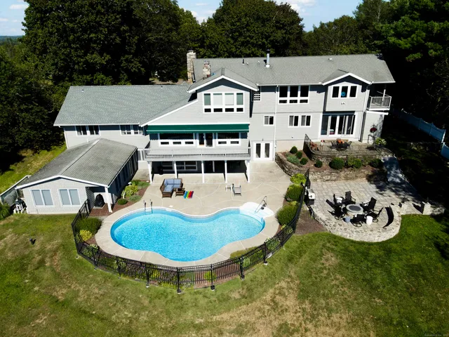 a aerial view of a house with a yard table and chairs