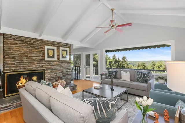 a living room with furniture fireplace and a flat screen tv