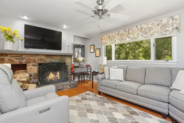 a living room with furniture fireplace and flat screen tv
