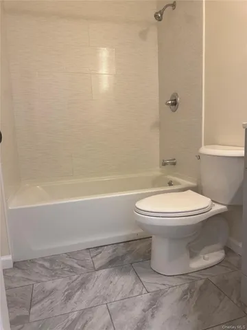 a bathroom with a toilet a sink and shower