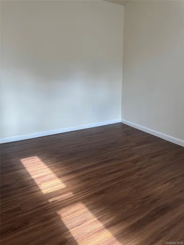 a view of room with wooden floor