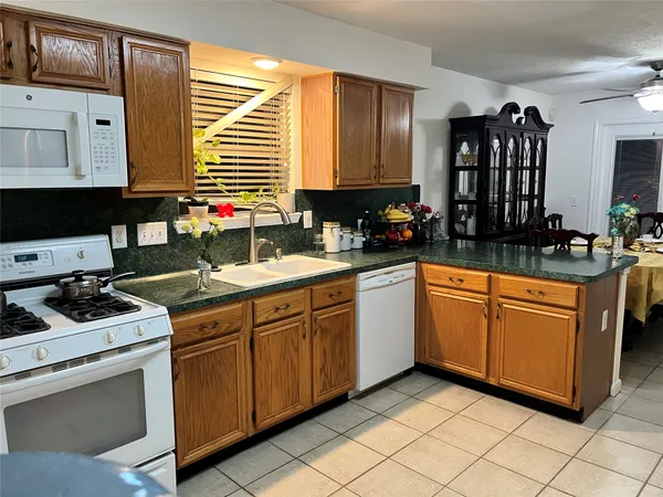 a kitchen with stainless steel appliances a sink stove and cabinets