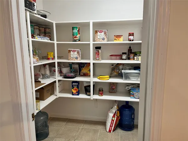 a shelf with cup and plates