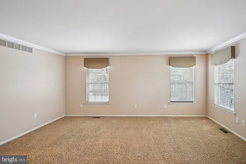a dining room with wooden floor and chandelier