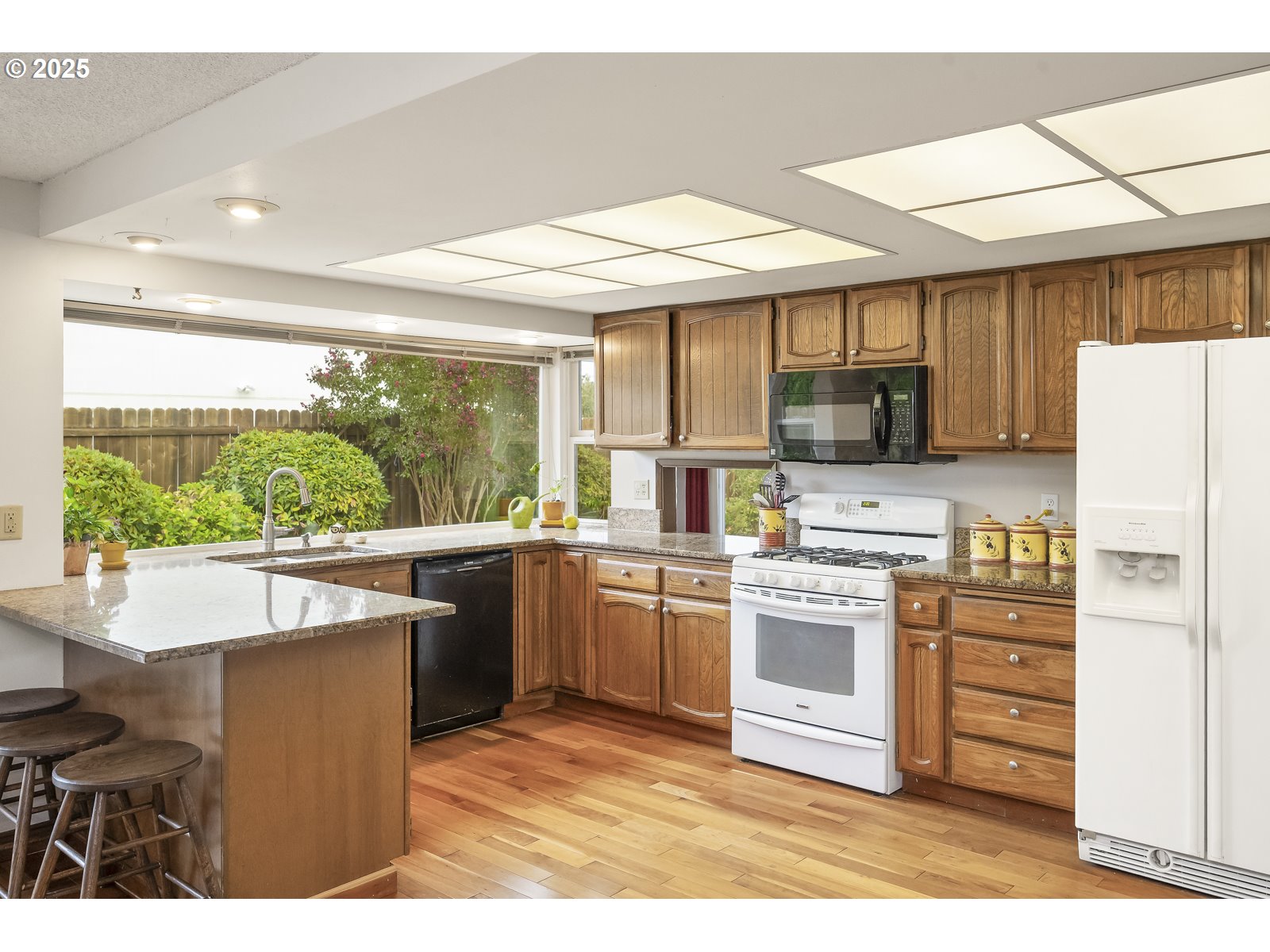 490 Southwest Nancy Avenue Gresham, OR 97030 - Photo 12 of 37 a kitchen with stainless steel appliances granite countertop a stove a sink and a refrigerator