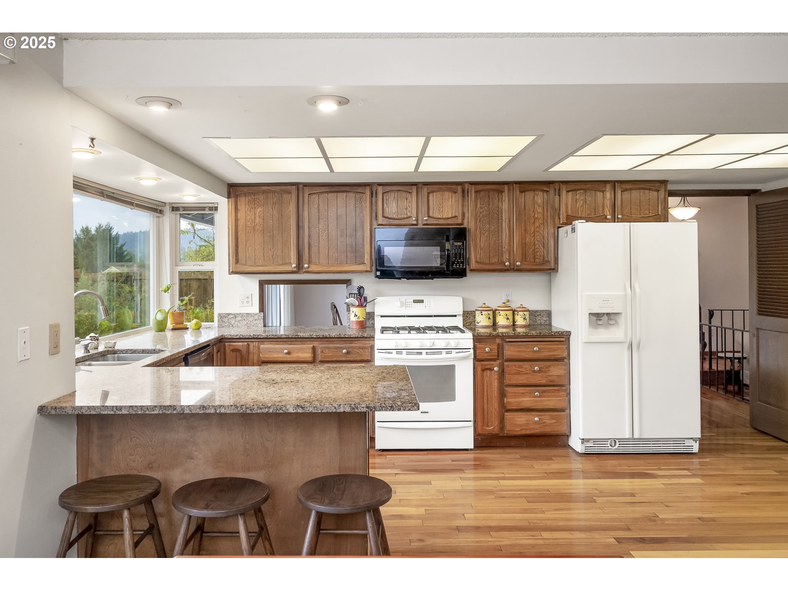 490 Southwest Nancy Avenue Gresham, OR 97030 - Photo 13 of 37 a kitchen with stainless steel appliances granite countertop a stove a sink and a refrigerator